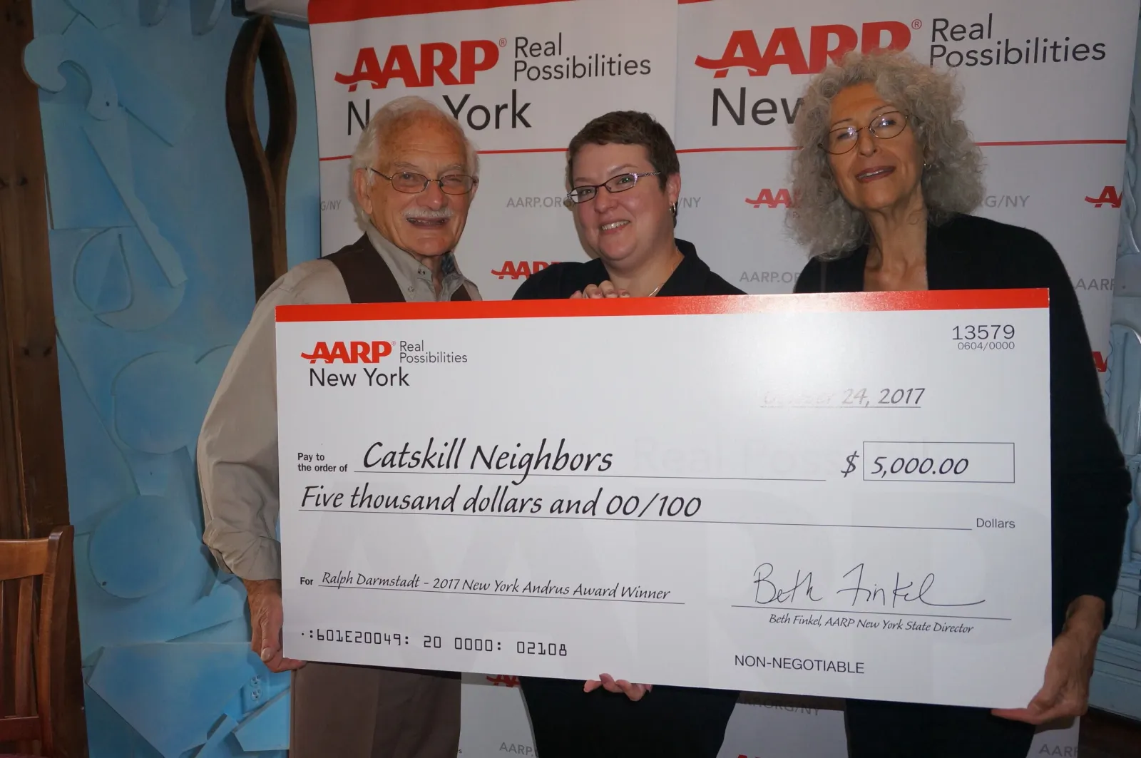 Ralph Darmstadt receives an award from AARP.